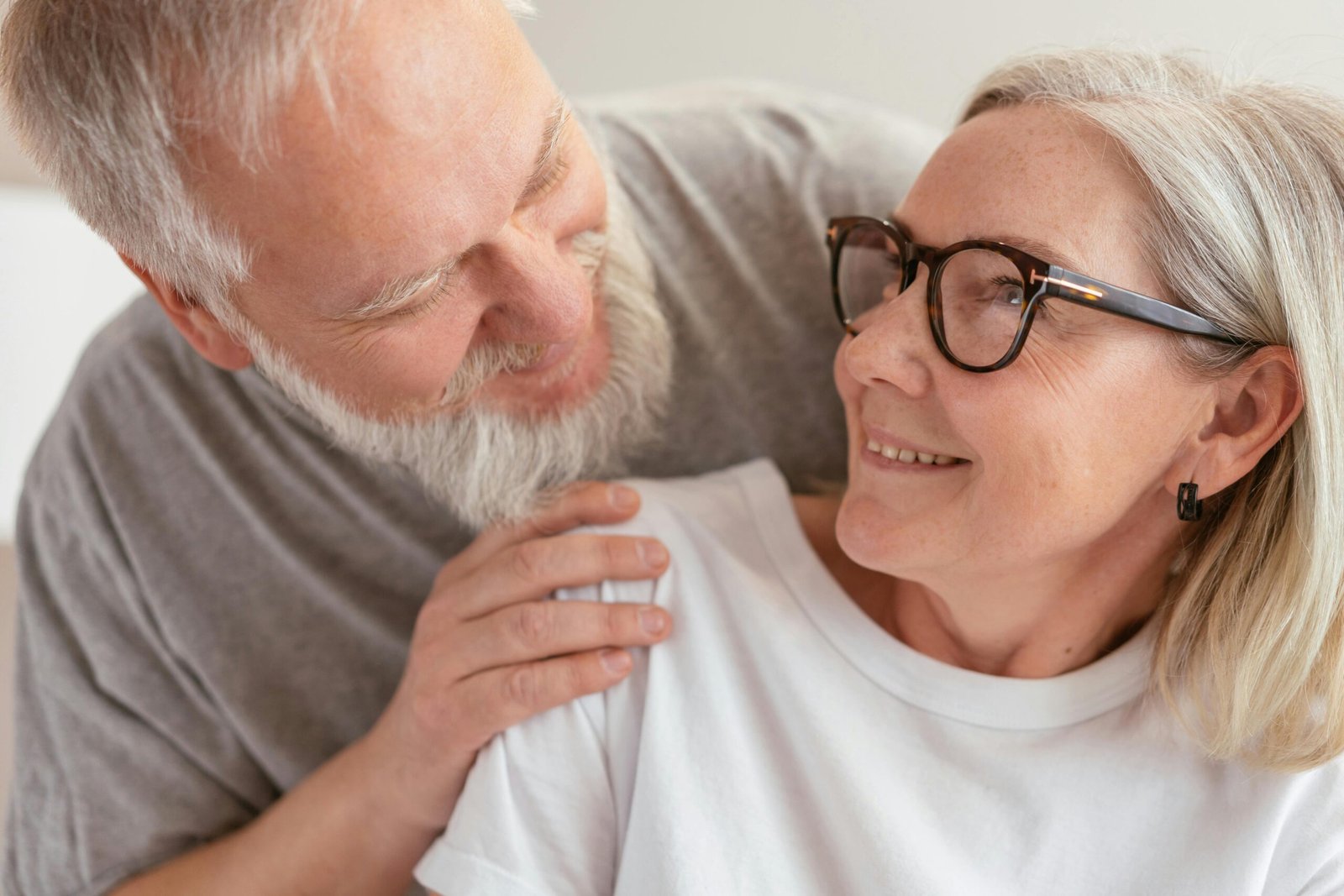 smiling mature couple with man looking over womans shoulder